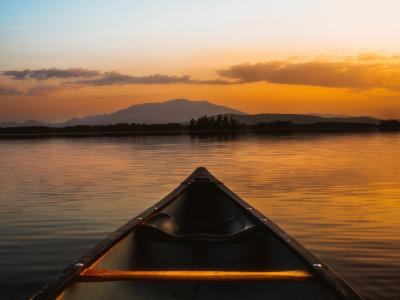 canoe on the water during sunset