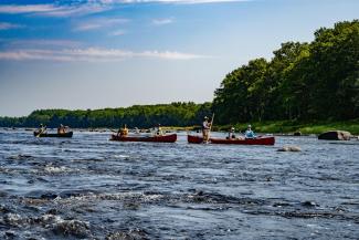 A group of people canoeing down a river