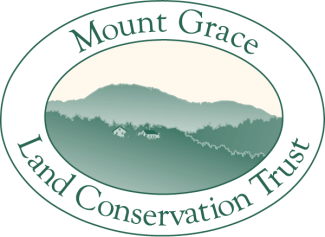 White and green oval with org name surrounds landscape illustration of mountain forests and building