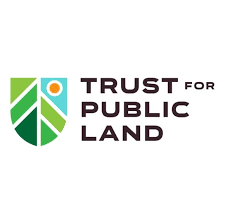 Shield-shaped symbol with abstract lines suggesting forest with blue sky above, org name to the right